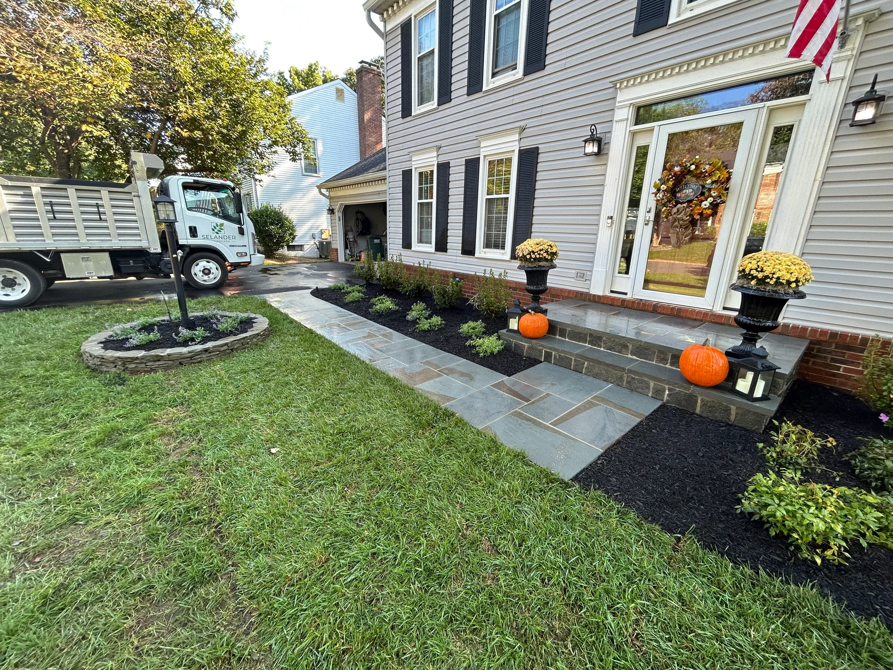 Stone walkway bordered by lush landscaping
